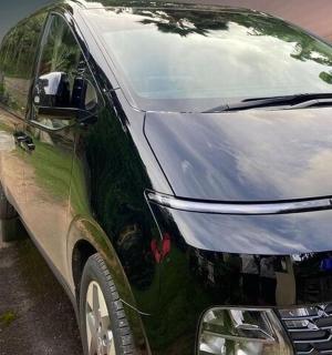 a green van parked on the side of a street