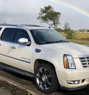 a white truck parked on the side of a road with a rainbow