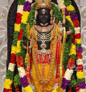 a statue of a god is covered in flowers