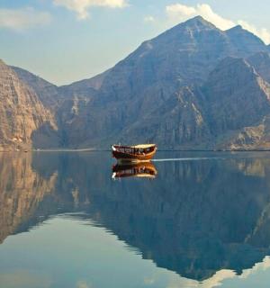 a boat on a body of water with mountains