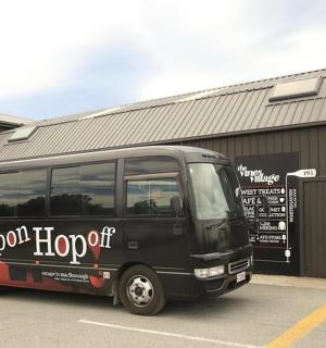 a black bus parked in front of a building