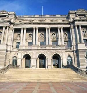 a large white building with stairs in front of it