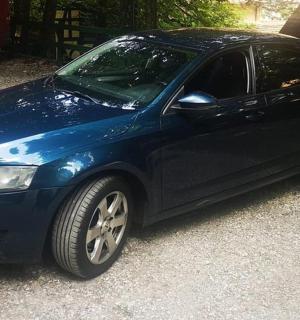 a blue car is parked in a driveway