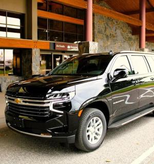 a black and white car parked in front of a building
