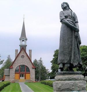 a statue of a woman in front of a church