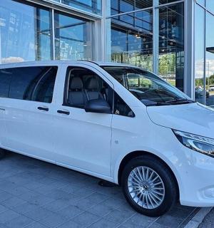 a white van parked in front of a building