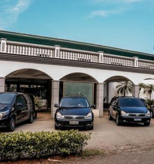 three cars parked in a parking lot in front of a building