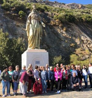 a group of people standing in front of a statue
