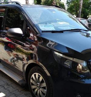 a black car with an advertisement on the side of it