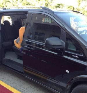 a black van parked in a parking lot with its door open