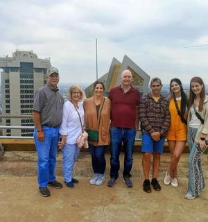 a group of people standing on top of a building
