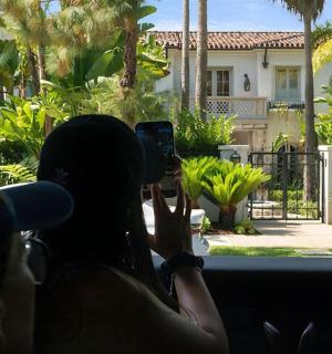a woman taking a picture of a house