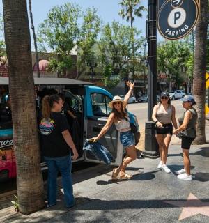 a group of people standing outside of a food truck