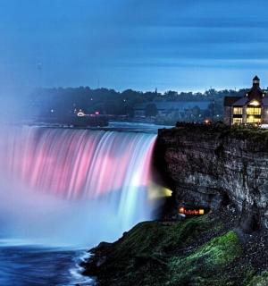 a view of a waterfall at night with a rainbow