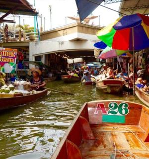 a group of people in boats in a market