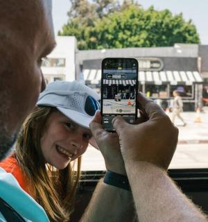 a man taking a picture of a woman with a cell phone