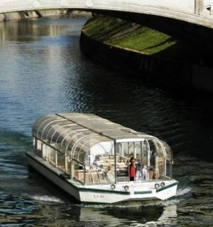 a boat in the water under a bridge