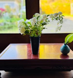 a table with a vase and a plant on it