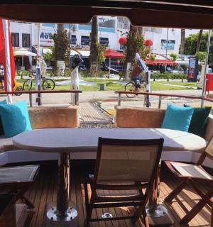a table and chairs on the deck of a boat