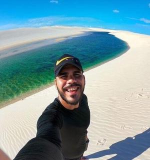 a man sitting on the beach near the ocean