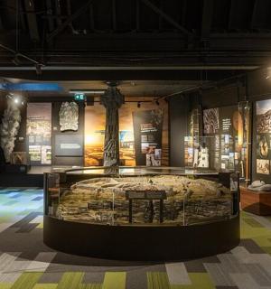 a museum with a bed in a display case