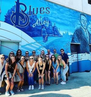 a group of people standing in front of a building