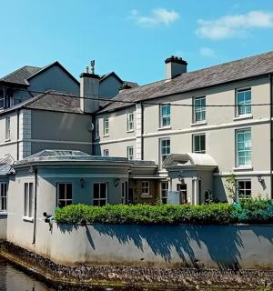 a large white building next to a body of water