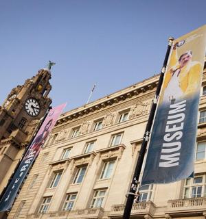 a building with a clock tower and a banner on it