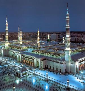 a large building with a mosque with a lot of people