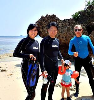 a group of people standing on the beach