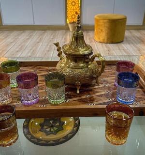 a tea kettle and glasses on a table