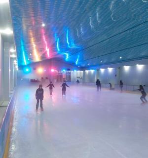 a group of people skating on an ice rink
