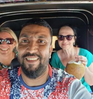 a man and two women sitting in the back of a car