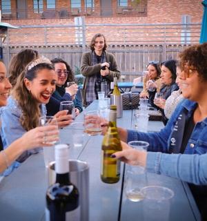 a group of people sitting at a table with wine glasses