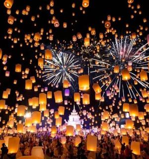 a crowd of people with thousands of lanterns at night