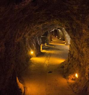 a tunnel with lights in the end of a tunnel