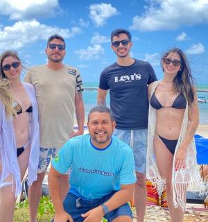 a group of people standing on the beach