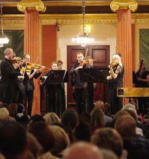 a group of people playing music in front of a crowd