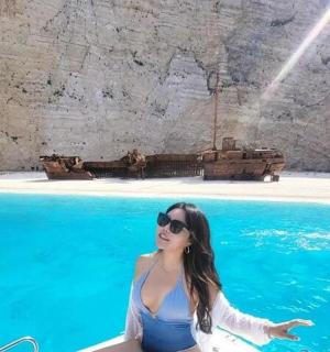 a woman sitting in a boat in the water