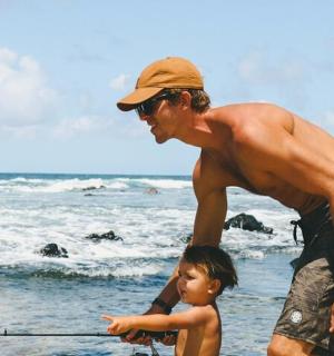 a man and a boy fishing on the beach