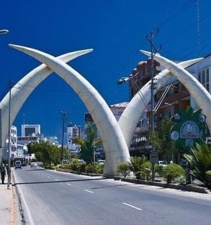 a building with a white archway in the middle of a street