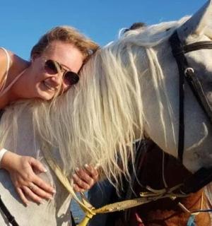 a woman riding on the back of a horse