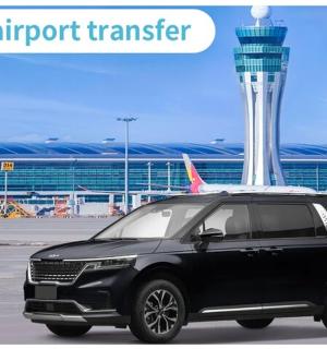 a black suv parked at an airport with an airport tower