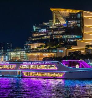 a boat in the water with a city at night