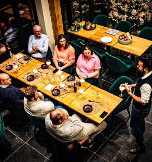 a group of people sitting at tables in a restaurant