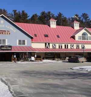 a large building with a red roof in a parking lot
