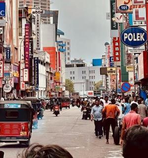 a crowd of people walking down a busy city street
