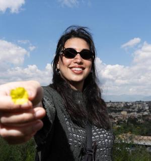 a woman holding a piece of food in her hand
