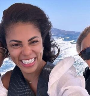 three women posing for a picture on a boat