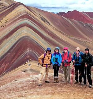 skupina lidí stojící na vrcholu hory